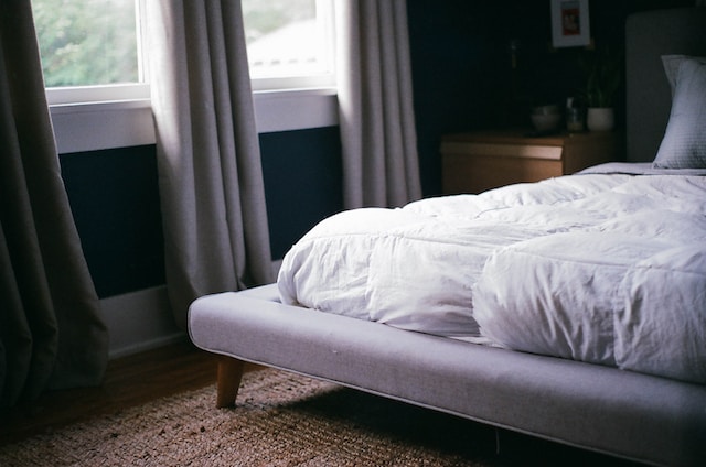 A clean mattress with white duvet